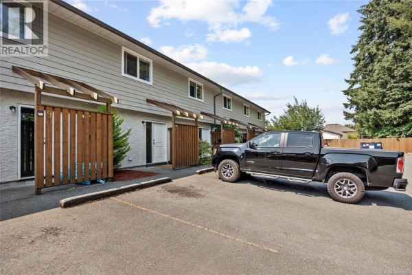 View into an open townhouse door showing stairs, entryway, and hallway. - 10 951 17th St, Courtenay