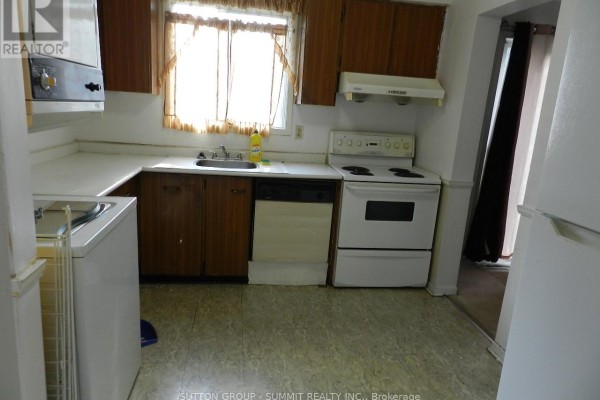 Kitchen with wood cabinets, white appliances, and a window with curtains. - 10 Baldoon Road, Toronto