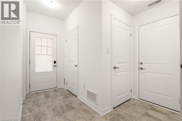 Open concept living space with kitchen, island, and staircase. - 10 Birmingham Drive Unit# 129, Cambridge