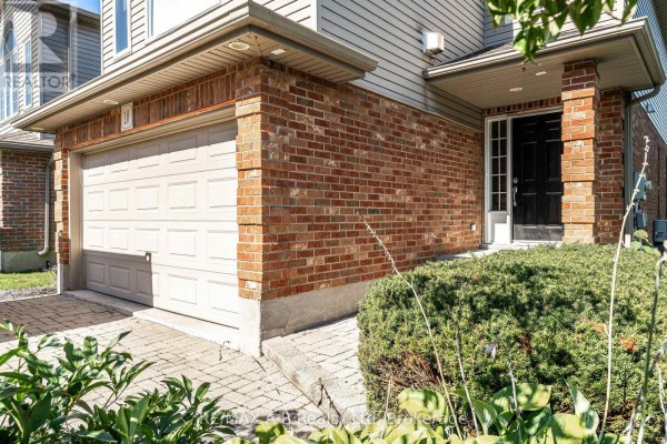 Close-up of the brick exterior, garage door, and entrance to the home. - 10 Buckingham Drive, Stratford