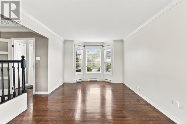 Empty living room with dark hardwood floors and a bay window. - 10 Clevedon Crescent, Paradise