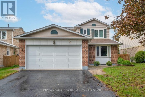 Front exterior of a two-story brick and vinyl house with a double garage door and driveway. - 10 Colette Drive, Whitby