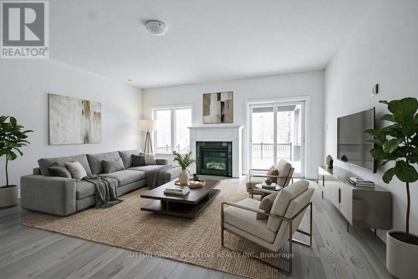 A staged living room with a sectional sofa, fireplace, and large windows. - 10 Cottonwood Street, Springwater