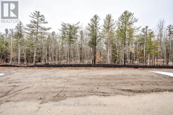A cleared, empty lot with surrounding trees and a cloudy sky. - 10 Cottonwood Street, Springwater