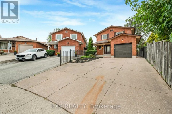 Street view of two red brick houses and paved driveways. - 10 Donegel Place, Hamilton