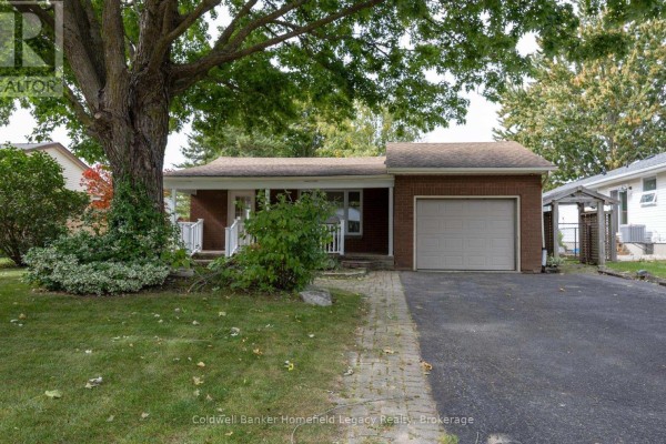 One-story brick house with a single garage door and mature tree. - 10 Dunsford Crescent, St  Marys