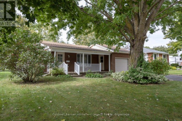 Side view of a brick bungalow with a large tree in the front yard. - 10 Dunsford Crescent, St  Marys