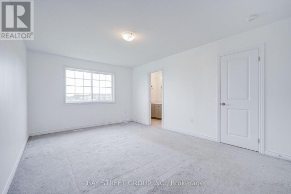 Bathroom with dual vanity, large mirror, and tub - 10 Elsegood Drive Guelph