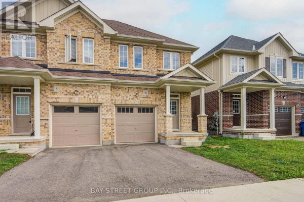 Side view of 10 Elsegood Drive and adjacent properties, showcasing the brick and siding exteriors. - 10 Elsegood Drive, Guelph