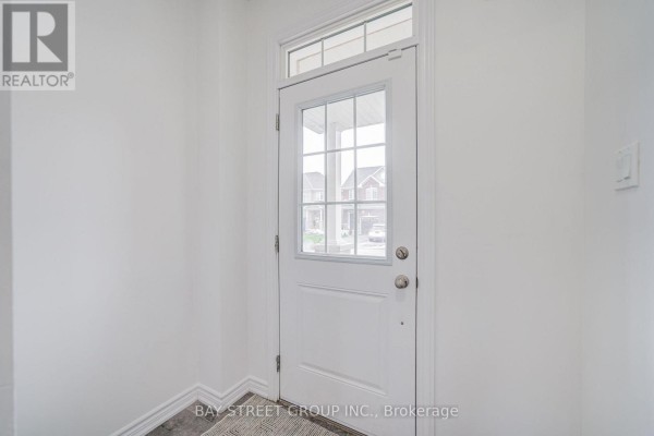 Interior view of the front door at 10 Elsegood Drive, looking out to the street. - 10 Elsegood Drive, Guelph