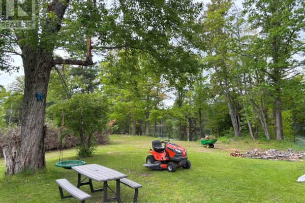 Two-story house with stone foundation and light purple siding, surrounded by trees. - 10 Fire Route 19 Route, Havelock Belmont Methuen