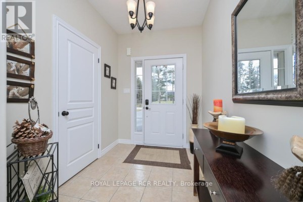 Living and dining area with dark hardwood floors and large arched windows. - 10 Fisher Drive, Adjala Tosorontio
