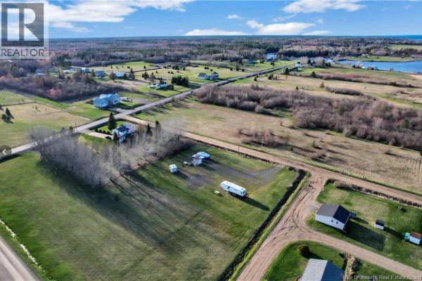 Aerial view of rural land with houses, RVs, and dirt roads. - 10 Florina Street, Cocagne