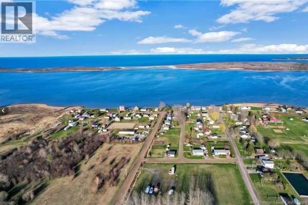 Aerial view of the Cocagne waterfront community with houses and the bay. - 10 Florina Street, Cocagne