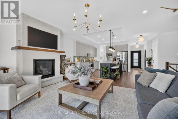 Living room with fireplace and kitchen island - 10 Granite Street Clarence Rockland