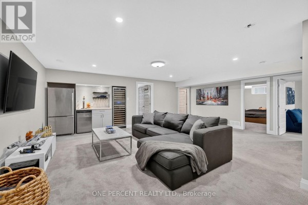 Modern basement living room with sectional sofa, wet bar, and wine fridge - 10 Granite Street Clarence Rockland