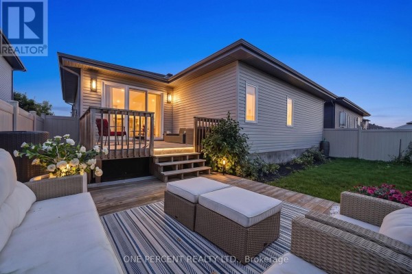Backyard deck with patio furniture, rug, and outdoor lighting - 10 Granite Street Clarence Rockland