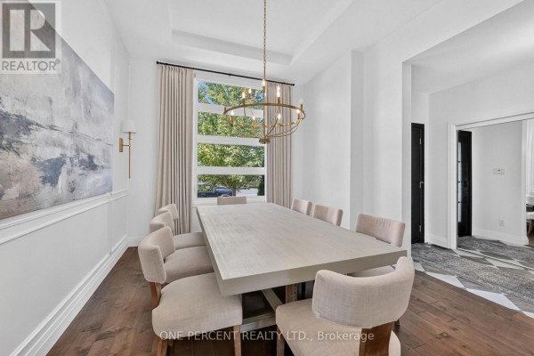 Dining room with table, chairs, modern chandelier, abstract art, and large window - 10 Granite Street Clarence Rockland