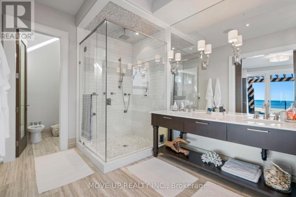 Interior entryway with double glass doors, wooden bench with art, and glass staircase railing. - 10 Hiawatha Avenue, Wasaga Beach