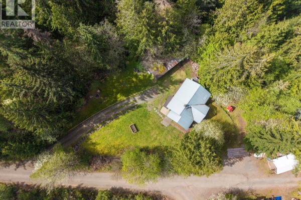 Overhead view of a grey house with a metal roof, surrounded by trees and a gravel driveway. - 10 Horbury Rd, Cumberland