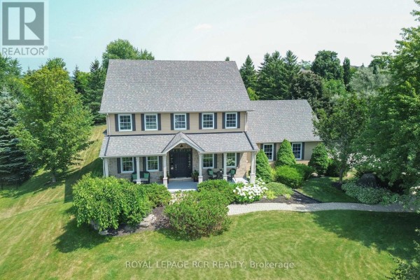 Aerial view of the house and surrounding mature trees and distant neighborhood. - 10 Island Lake Road, Mono