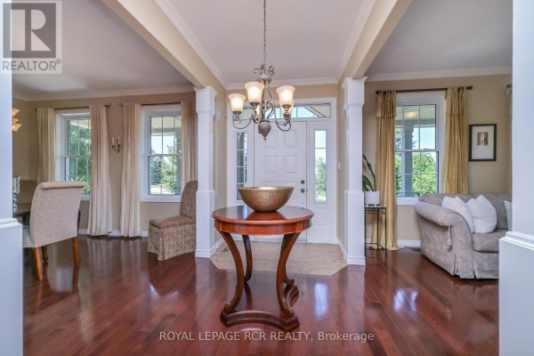 Interior foyer with dark hardwood floors, decorative chandelier, and furniture. - 10 Island Lake Road, Mono