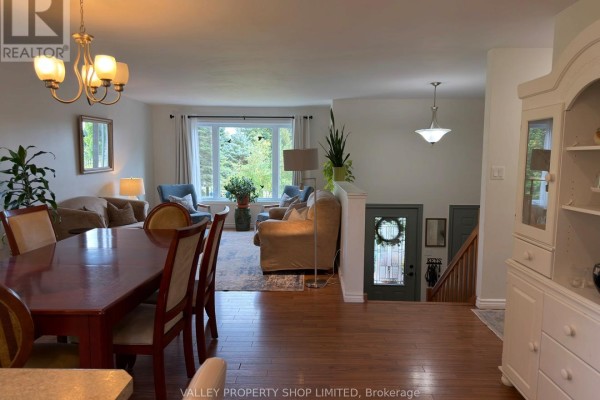 Open-concept living and dining area with hardwood floors and a view of the front entrance. - 10 Kirk Court, North Algona Wilberforce