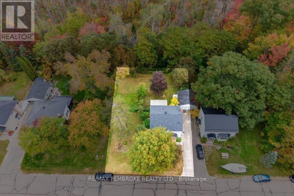 Overhead view of the residential property bordered by a forest with autumn foliage. - 10 Laurier Avenue, Deep River