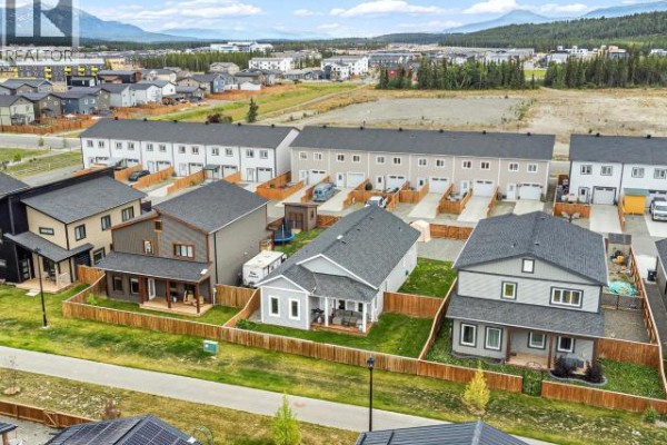 Aerial view of a residential street with townhouses and detached homes. - 10 Scotia Lane, Whitehorse