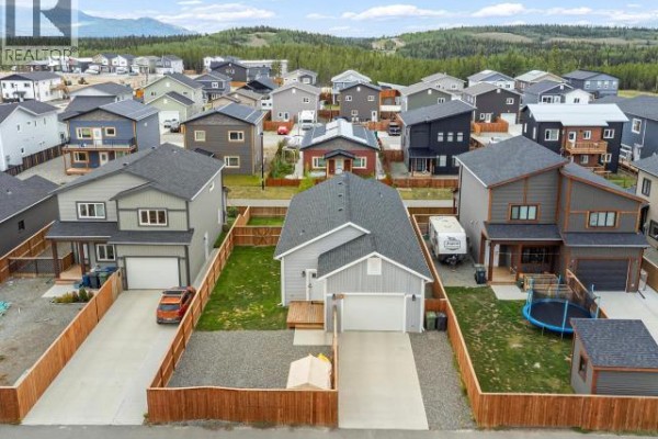 Aerial view of a street with houses, driveways, and fences. - 10 Scotia Lane, Whitehorse