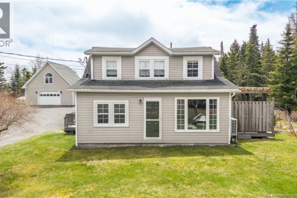 Exterior of a light beige house with a gray roof and white trim, featuring multiple windows. - 10 Stanley Oliver Road, Back Bay
