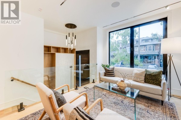 Cozy bedroom with a desk, stylish bedding, and access to a bathroom. - 10 Wheeler Avenue, Toronto