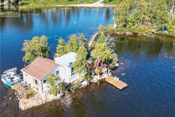 Aerial view of a small island with two structures and surrounding water. - 10 Whitson Lake Landing, Val Caron