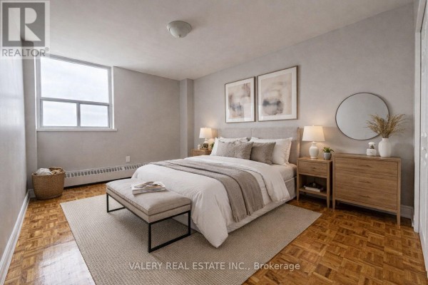 A bedroom with a king-size bed, nightstands, a dresser, and a window with a view. - 100 - 890 Jane Street, Toronto