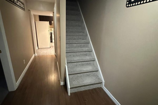 Hallway with staircase and "Now Playing" decor - 100 Southview Court Woodstock