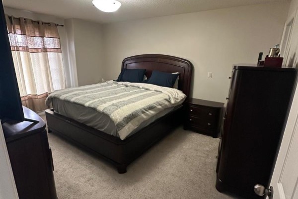 King bed with dark wood frame and dresser - 100 Southview Court Woodstock