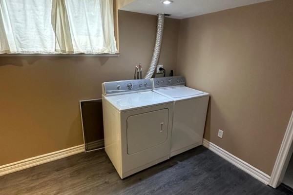 Washer and dryer in laundry room with laminate flooring - 100 Southview Court Woodstock