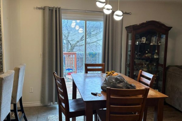 Dining room with table, china cabinet, and globe chandelier - 100 Southview Court Woodstock