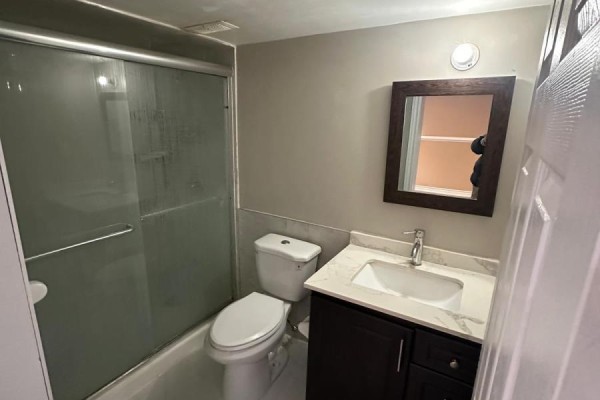 Bathroom with dark wood vanity, marble counter, and glass shower - 100 Southview Court Woodstock