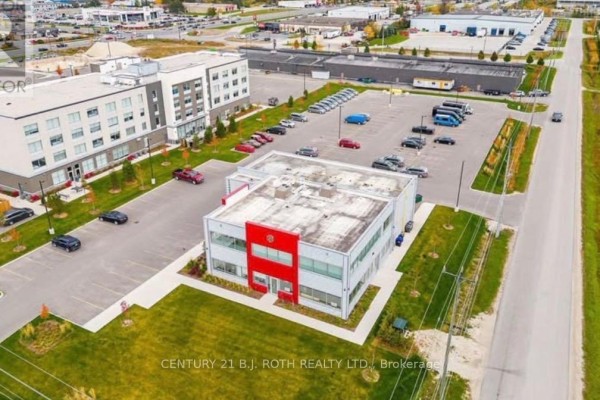 Aerial view of commercial building with parking lot and surrounding area - 100-office A - 245 Raglan Street E, Collingwood