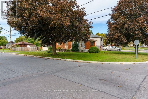 Corner view of the property with mature trees and neighboring houses. - 1001 Edythe Avenue, Cornwall