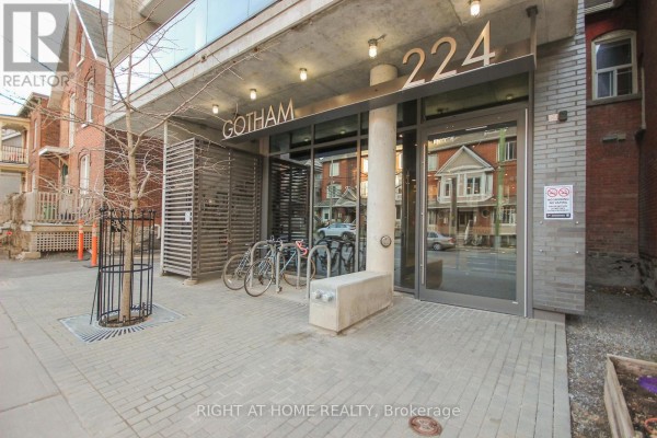 Street level view of the Gotham building entrance with bicycles parked at a rack. - 1002 - 224 Lyon Street, Ottawa