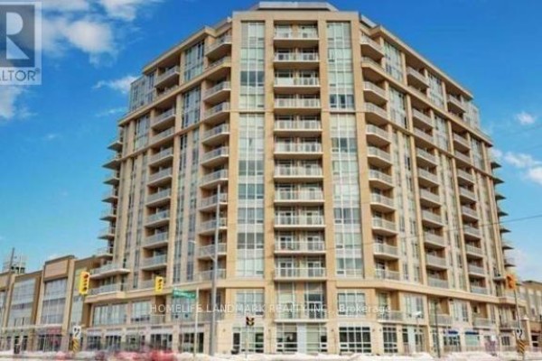 A tall, modern residential building with many balconies and windows, viewed from the street on a sunny day. - 1002 - 32 South Unionville Avenue, Markham