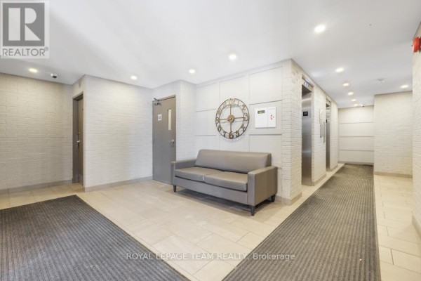 Hallway with sofa, clock, and elevators - 1004 - 40 Arthur Street E Ottawa