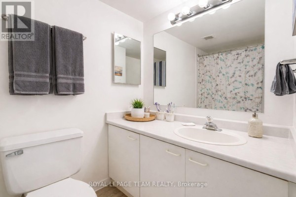 Bathroom with vanity, sink, mirror, toilet, and shower curtain - 1004 - 40 Arthur Street E Ottawa