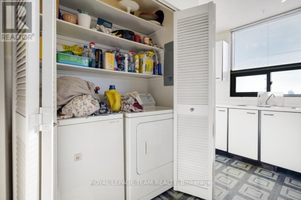 Laundry room with washer, dryer, and shelving - 1004 - 40 Arthur Street E Ottawa