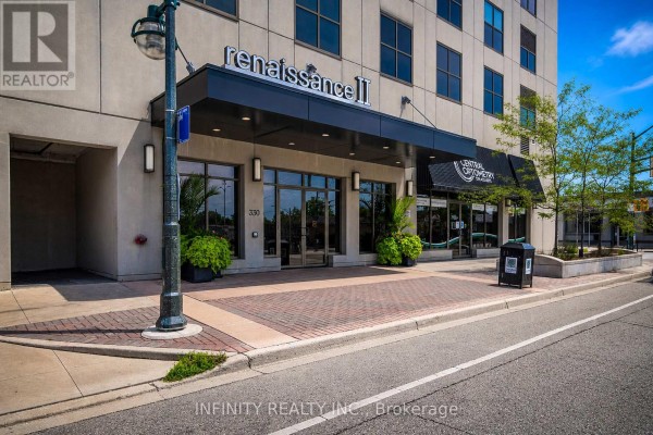 Kitchen with dark wood cabinets, stainless steel appliances, and patio access. - 1005 - 330 Ridout Street N, London East