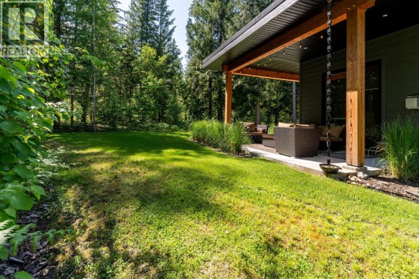 Patio view with wooden beams, storage, and snow-covered ground - 1005 Williams Gate Lane, Revelstoke