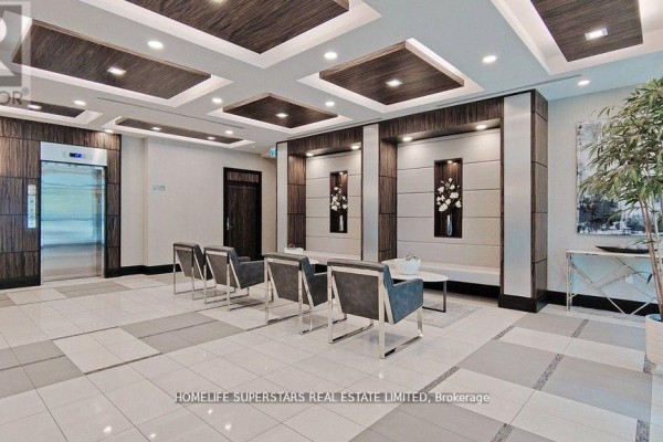 Living area with large windows overlooking the city and a balcony. - 1006 - 349 Rathburn Road W, Mississauga