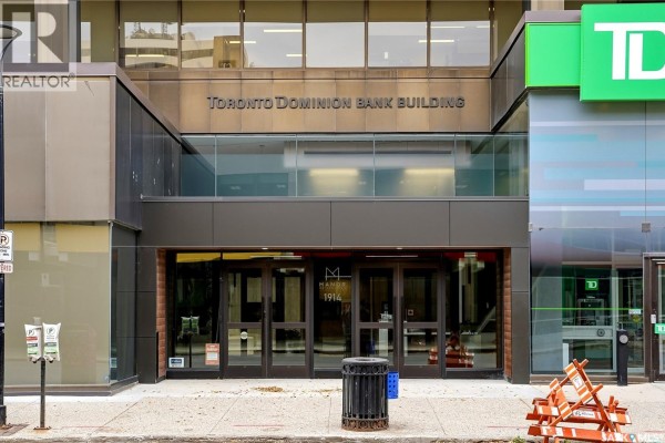 Main entrance to the Toronto Dominion Bank Building with glass doors and signage. - 1007 1914 Hamilton Street, Regina